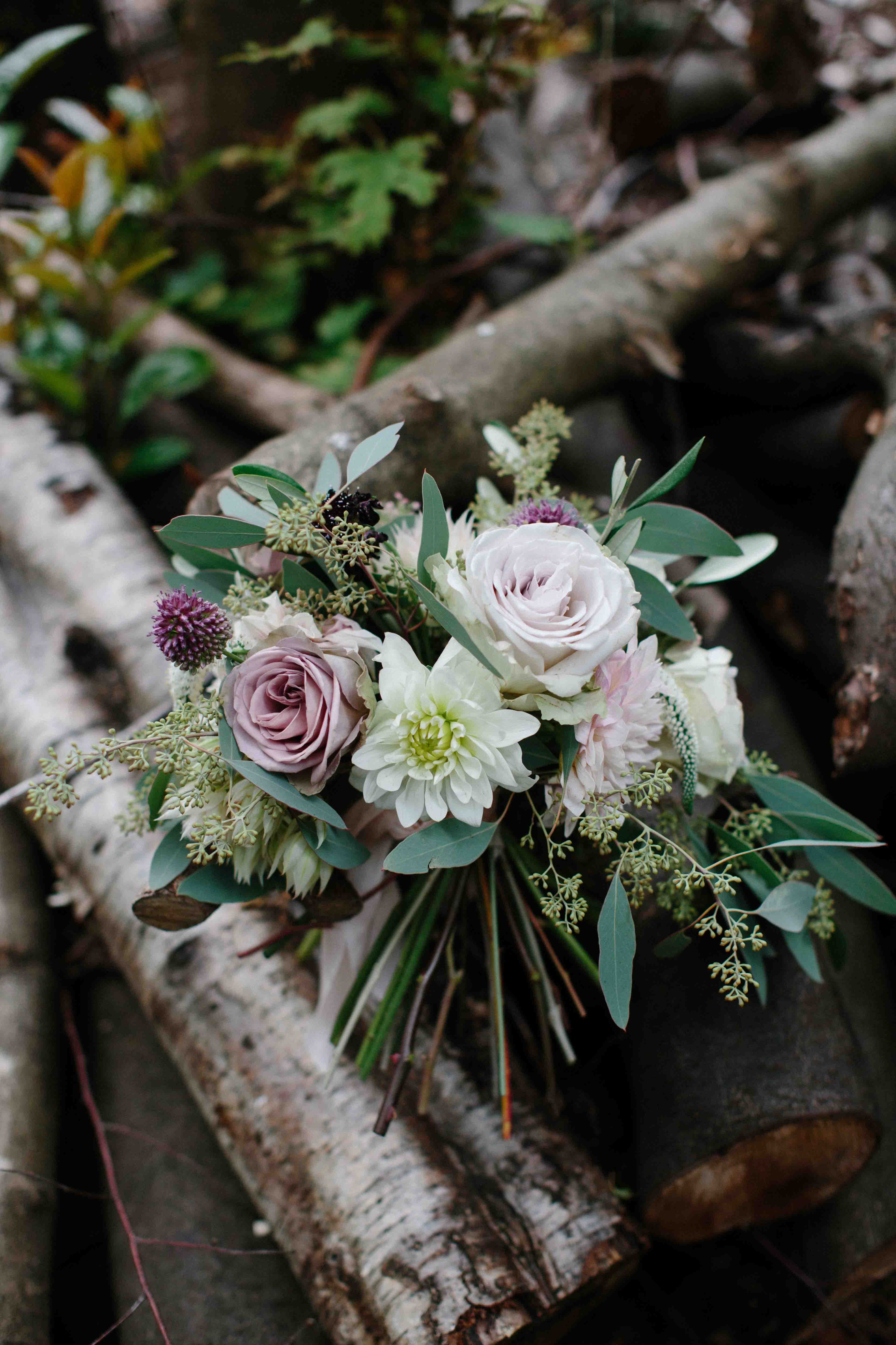 Bouquet on a pile of logs.