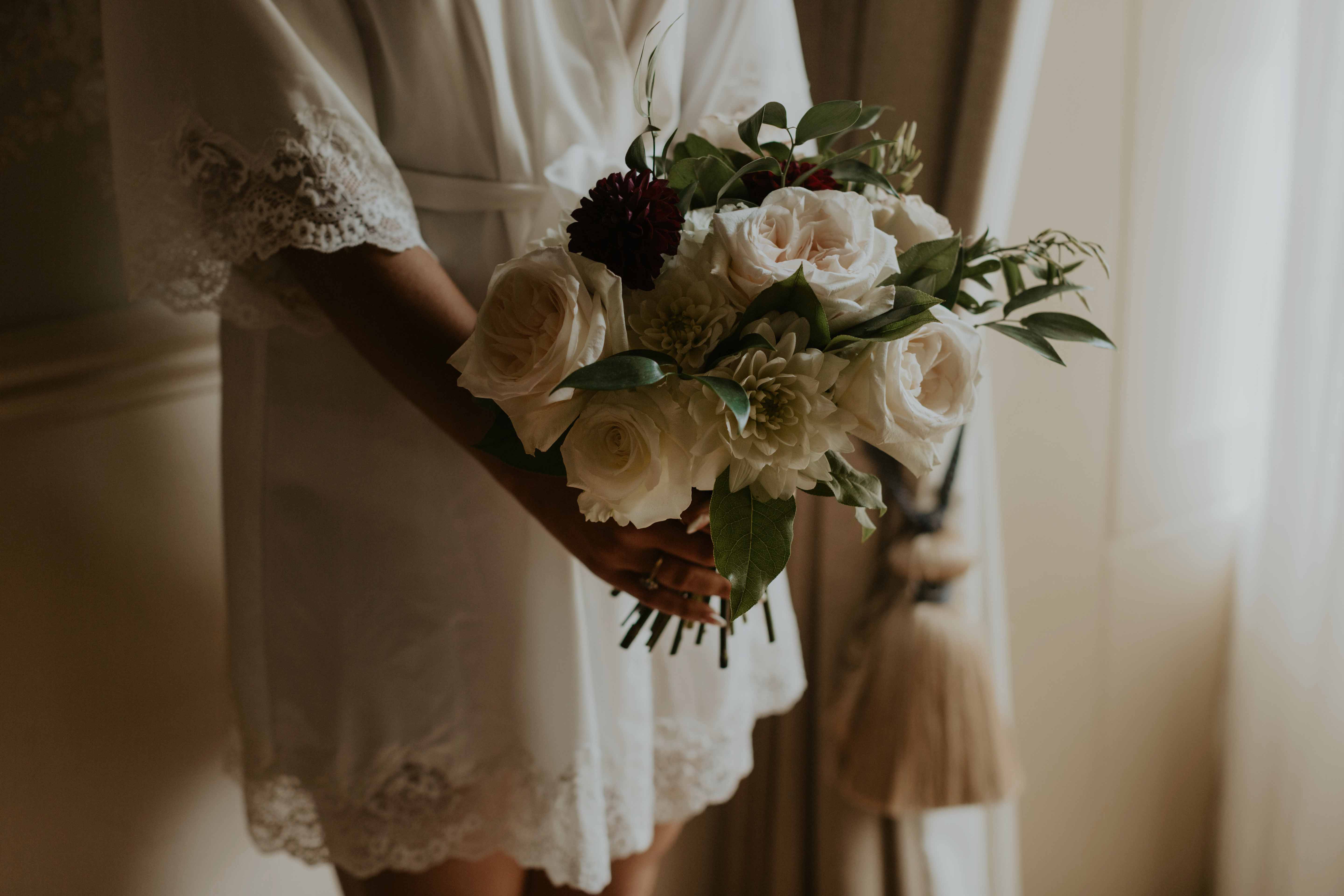 Bride holding bouquet robe.